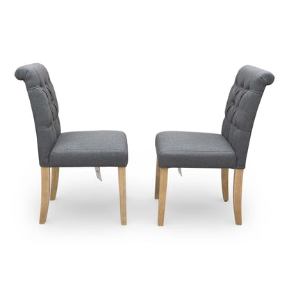 Side angle view of the ‘Lewis’ dining chair showing the uniform fabric coverage and fixed back construction.
