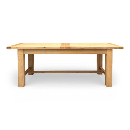 Full view of the Furnitureland ‘Augusta’ Large 220cm Rectangular Extending Dining Table in solid oak, showing its natural wood grain and sturdy construction.
