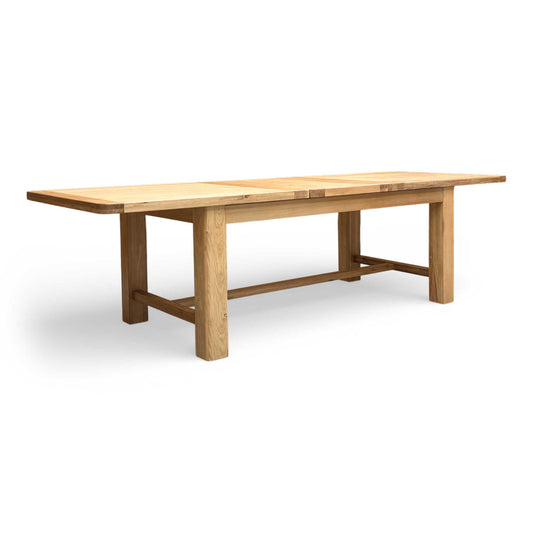 Full view of the Furnitureland ‘Augusta’ Large 220cm Rectangular Extending Dining Table in solid oak, showing its natural wood grain and sturdy construction.