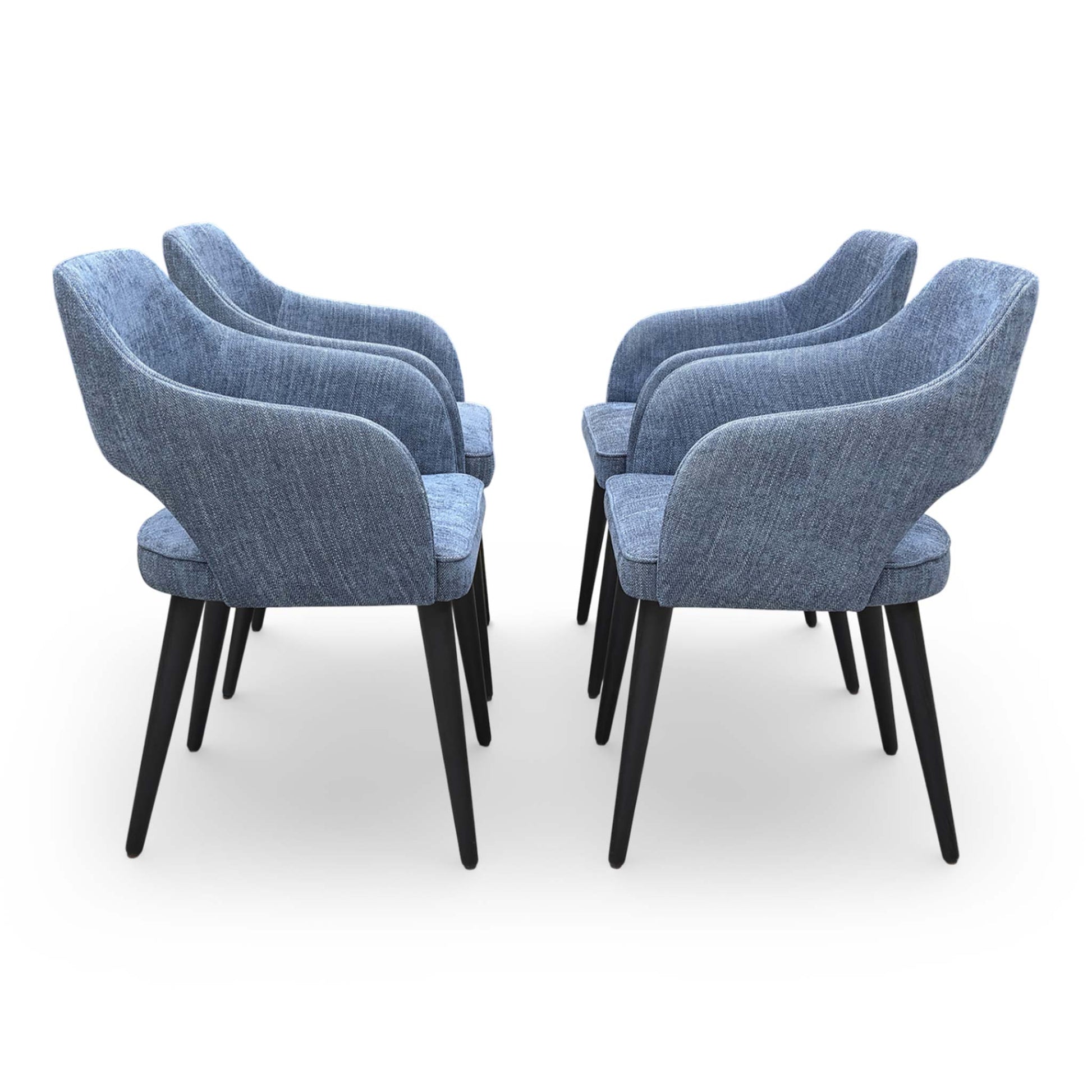 Side profile of the ‘Manu’ chair showing the sleek fixed metal frame and ergonomic seat depth.