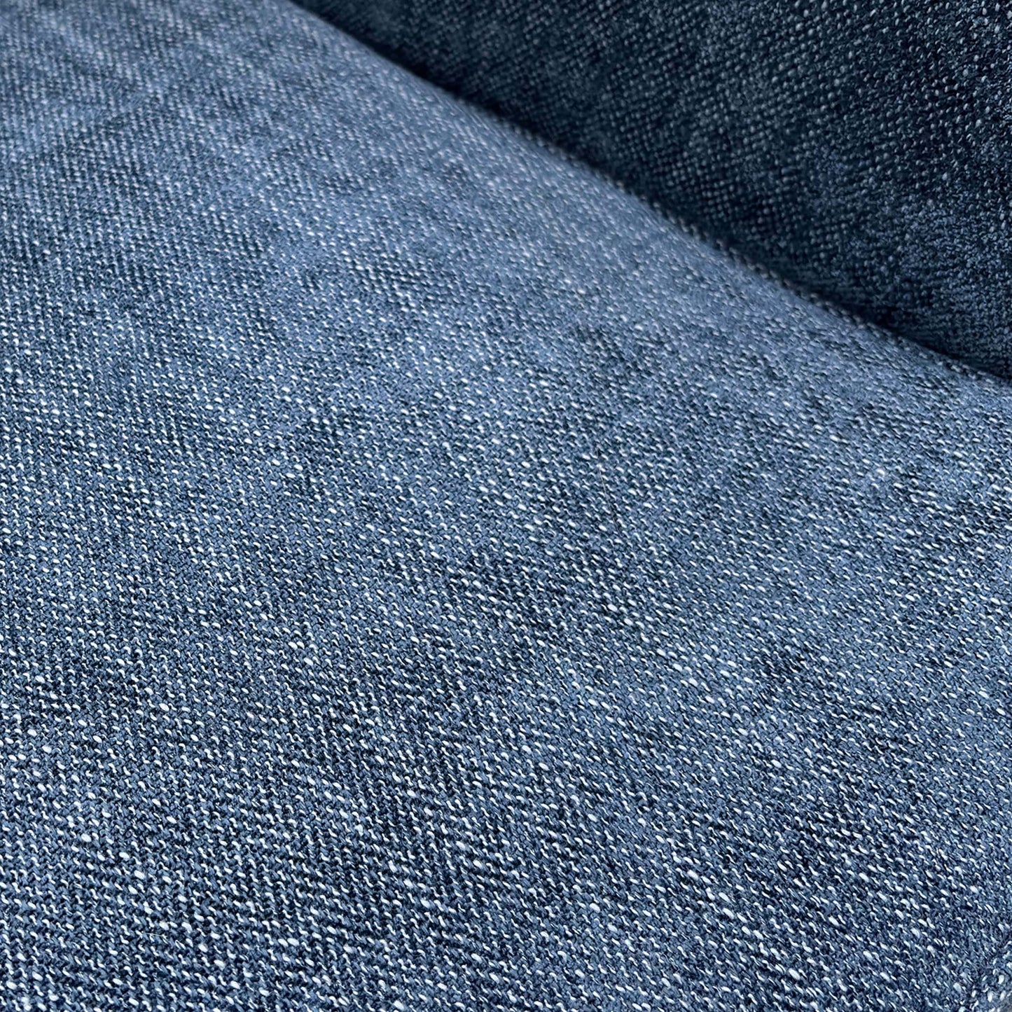 Close-up of the durable navy blue woven fabric upholstery and high-quality stitching on the seat.