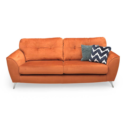 Front view of the DFS ‘Dawson’ 4 Seater Sofa in Marmalade velvet, featuring deep cushioning and a bold, contemporary silhouette.