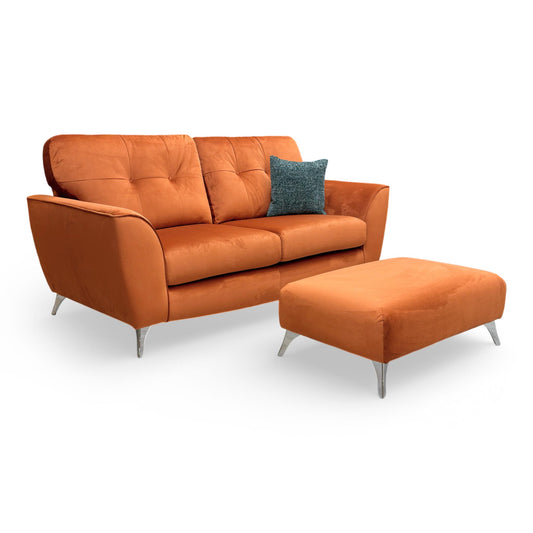 Full view of the DFS ‘Dawson’ 3 Seater Sofa and matching Bench Footstool in vibrant Marmalade velvet, featuring a mid-century modern design and high back.