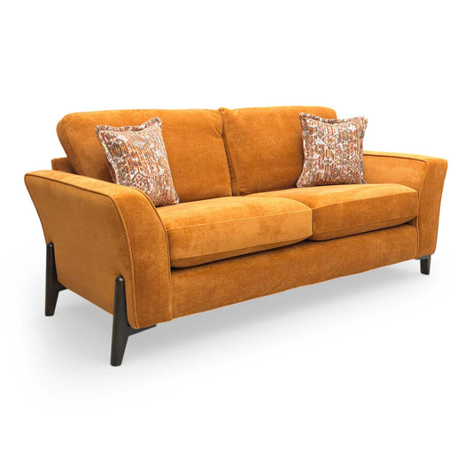 Full View The Thornbrook ‘Collins’ 3-seater sofa in Almond Orange towel velvet, featuring a modern sloped arm design and elegant wooden legs.