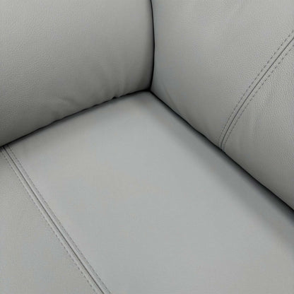 Close-up texture shot of the premium 100% top-grain grey leather upholstery and precision stitching.