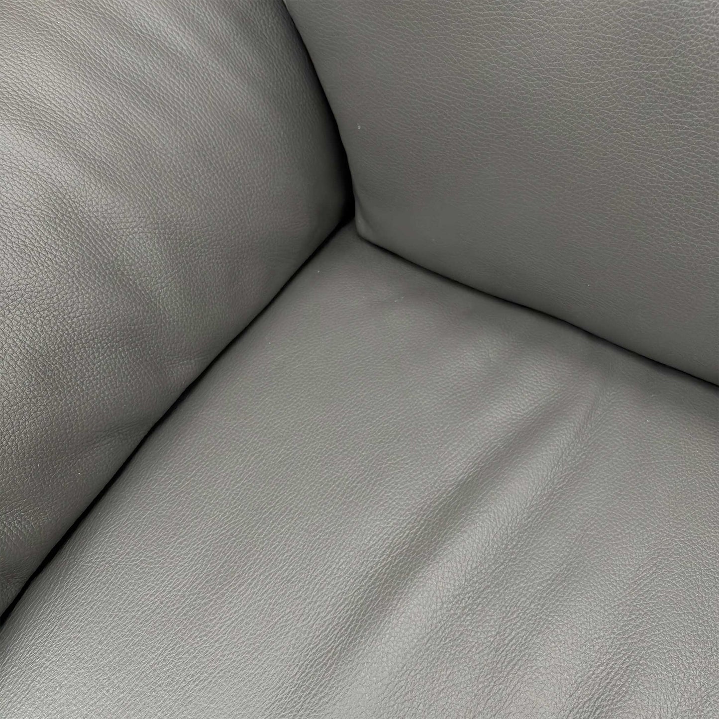 Side profile of the Nicoletti Pepino sofa, emphasizing the clean contemporary lines and the distinctive wide-track arm design.