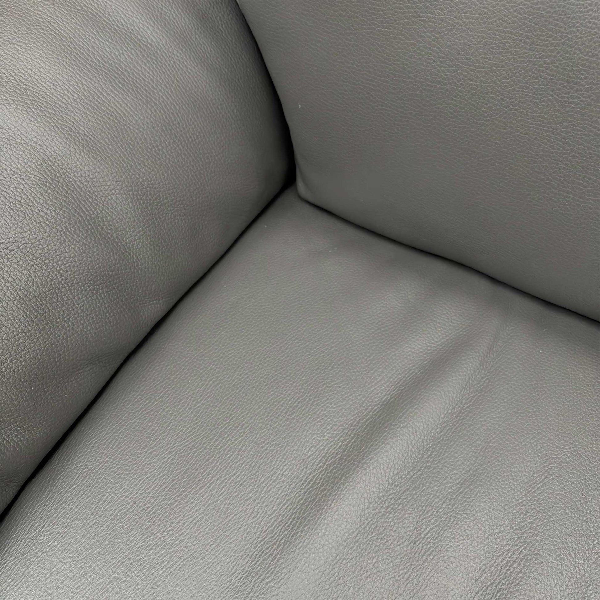 Side profile of the Nicoletti Pepino sofa, emphasizing the clean contemporary lines and the distinctive wide-track arm design.