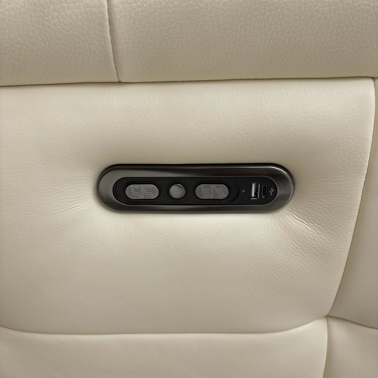 Close-up of the side-mounted power controls, including the USB charging port for convenient device charging while relaxing.