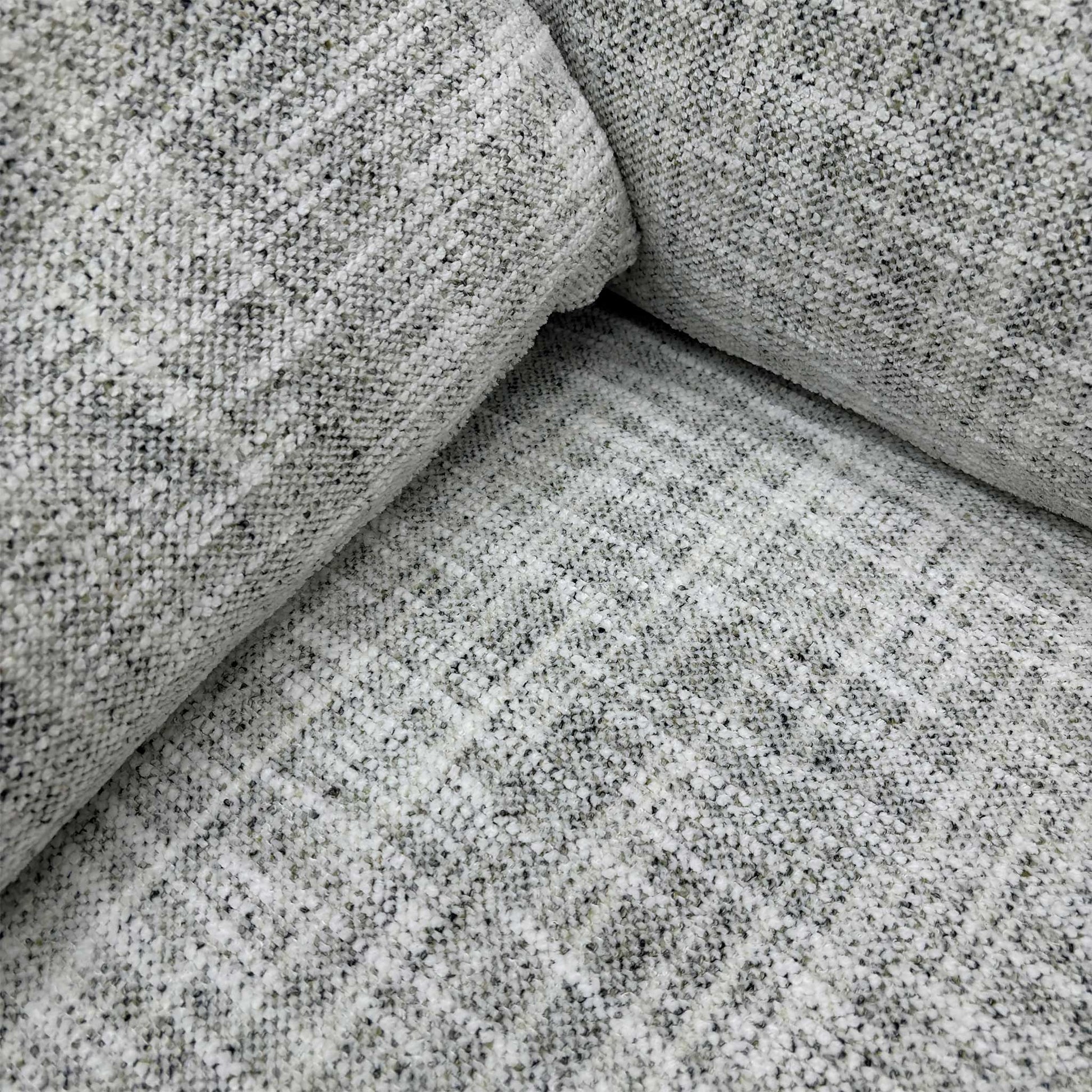 Detailed close-up of the Silver Green fabric and the simple buttoning detail on the backrest, emphasizing the sofa’s understated, elegant look.
