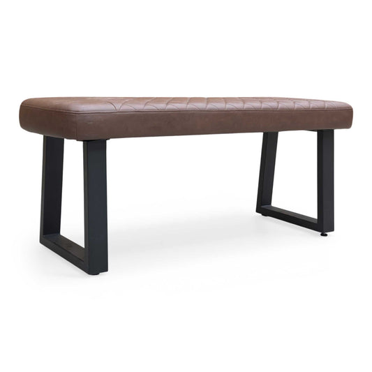 Full view of Furniture Village ‘Venus’ low dining bench upholstered in Tan Faux Leather with industrial black U-shaped metal legs.