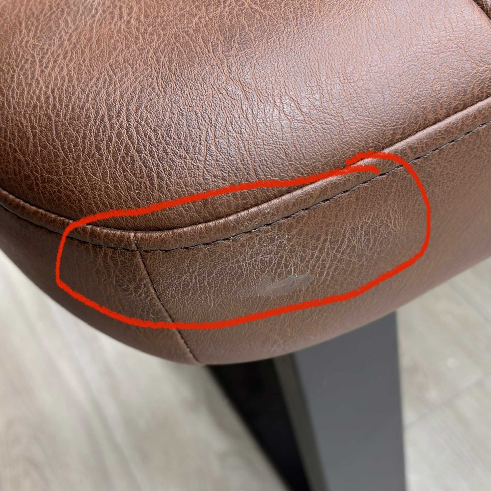 close-up of the tan faux leather material, showing the fine stitching and quality of the industrial finish.