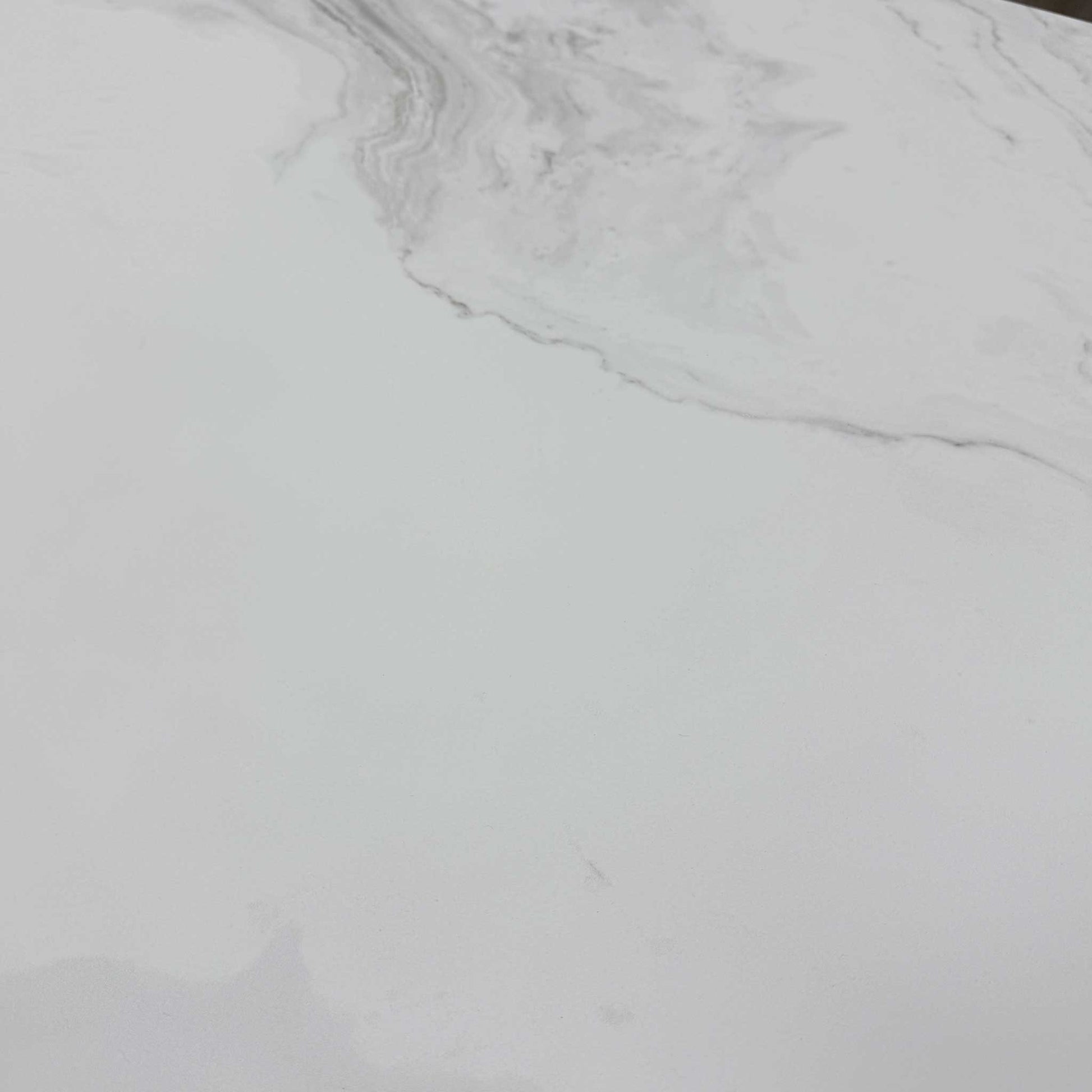 Close-up of the grey ceramic surface, highlighting the high-gloss marble-effect pattern and smooth finish.