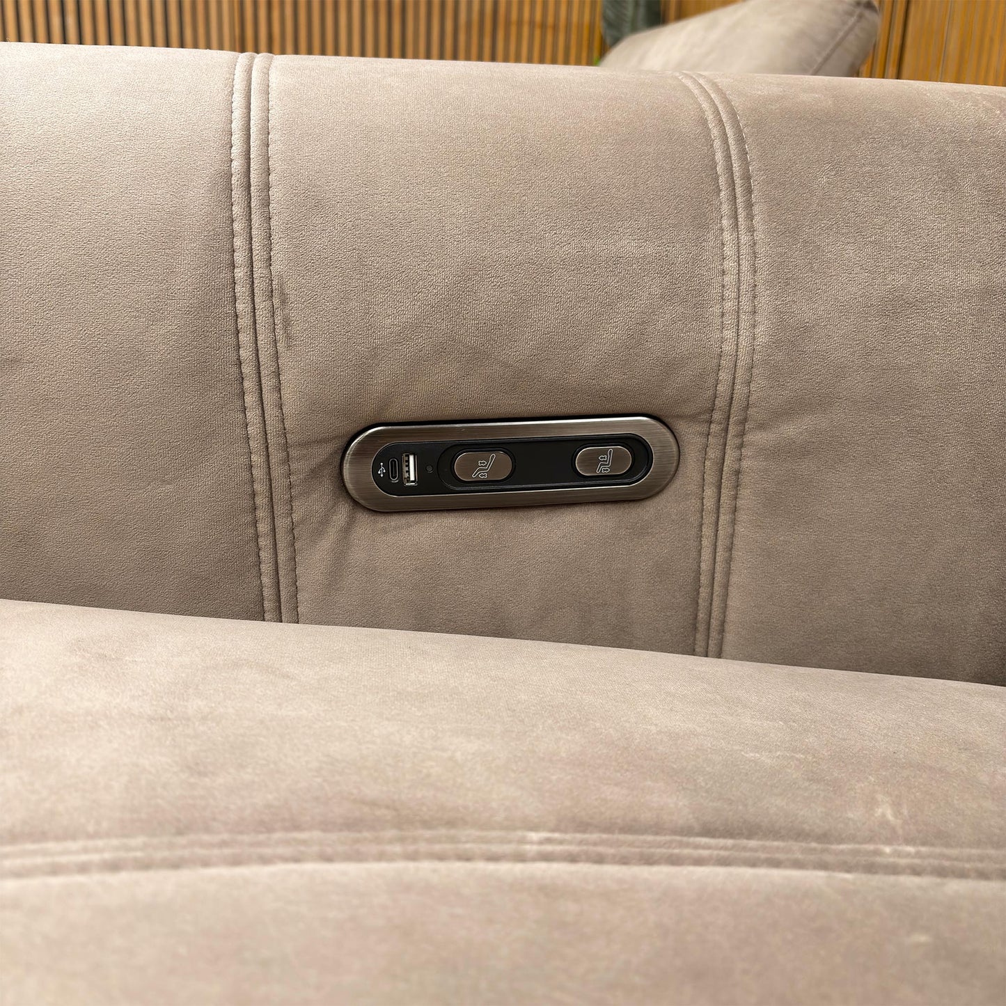 Close-up of the integrated power controls and USB charging port located on the inner arm of the sofa for easy access.