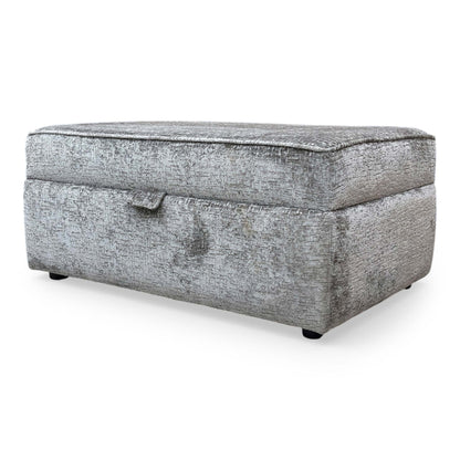Side profile of the Sasha storage ottoman, emphasizing the clean lines, tailored piping detail, and the sturdy, low-profile base.