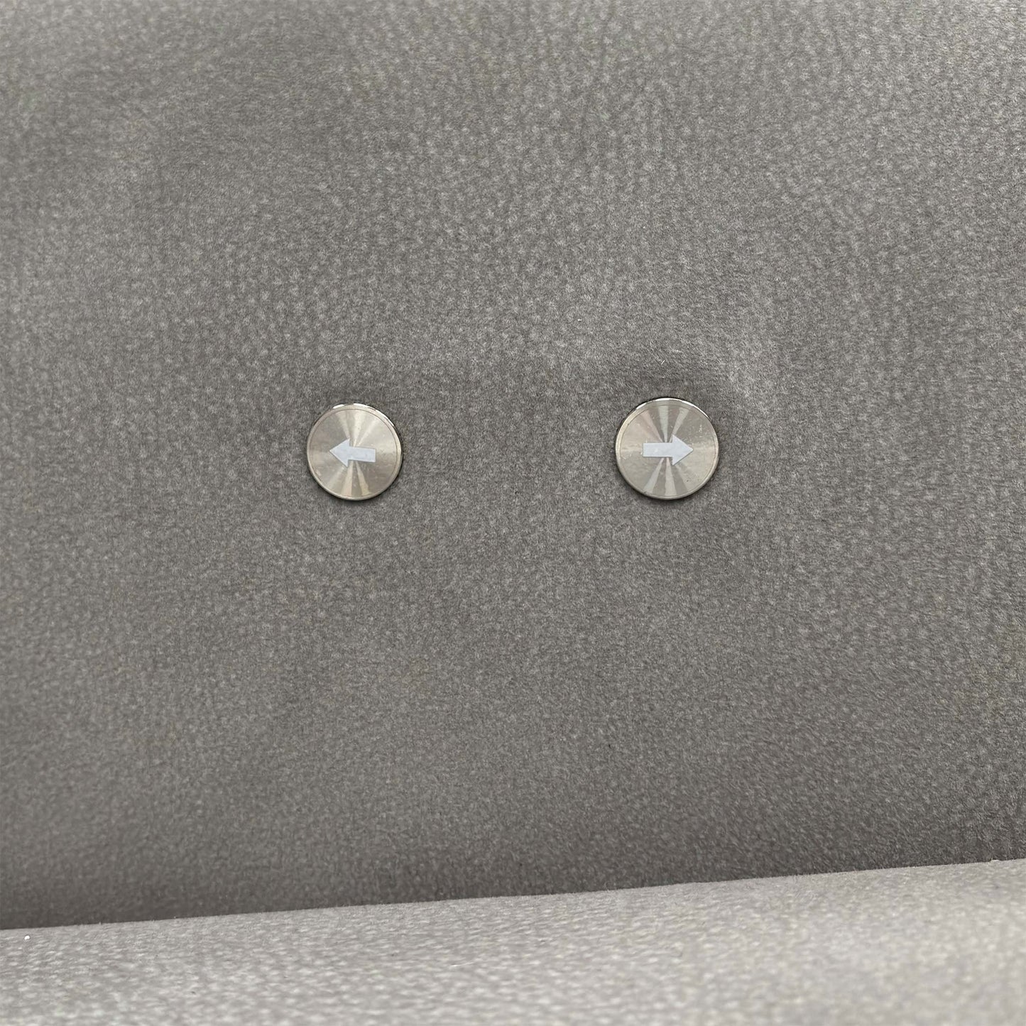 Close-up of the integrated power recliner controls on the side of the sofa arm.