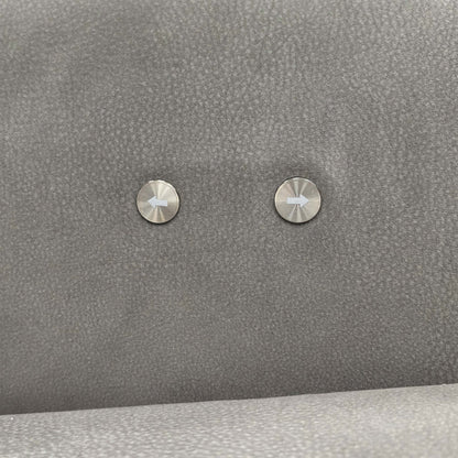 Close-up of the integrated power recliner controls on the side of the sofa arm.