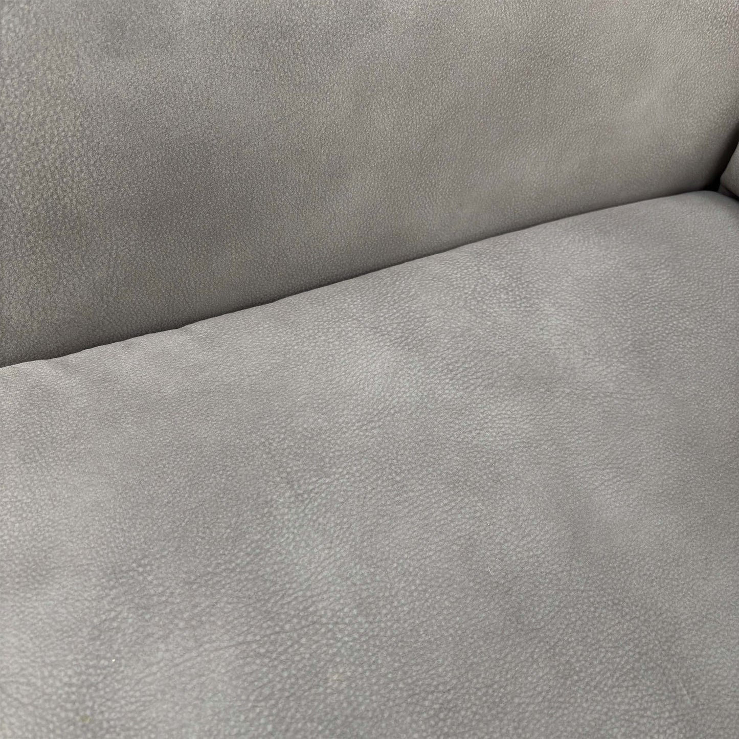 Close-up shot of the high-quality Dove Grey fabric upholstery and precision stitching details.