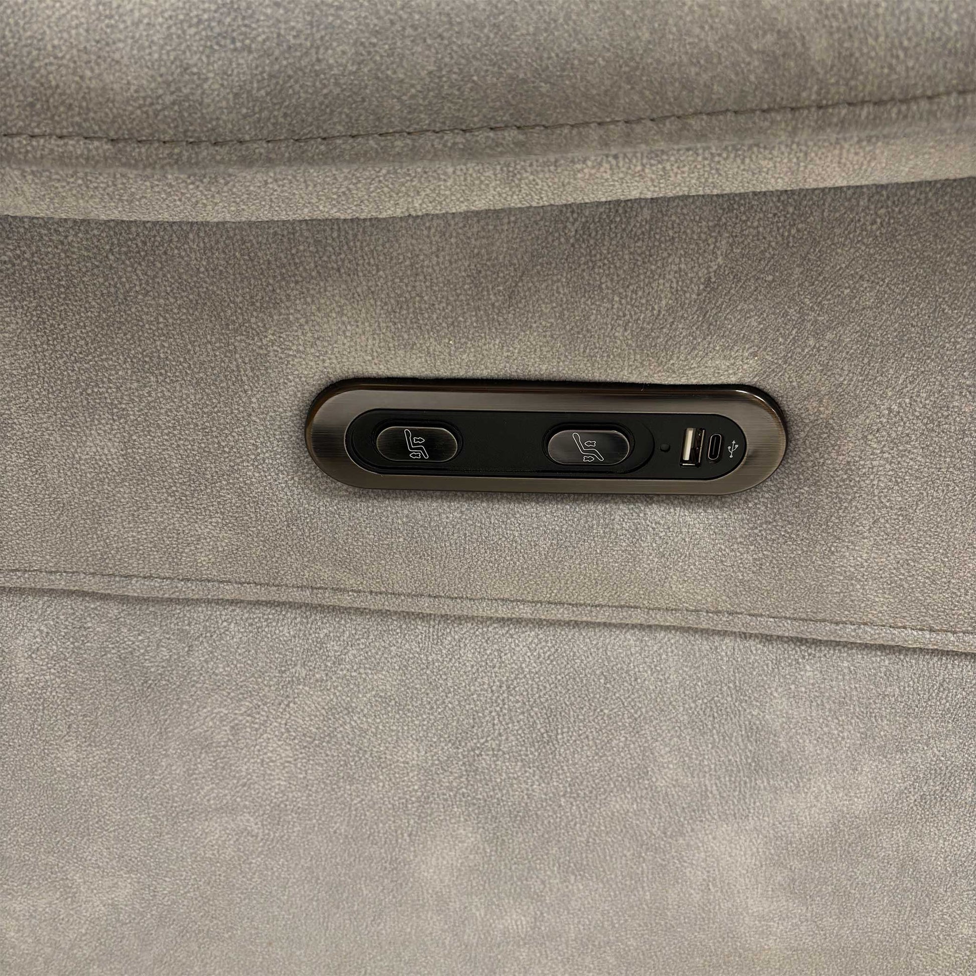 Close-up of the Daytona ‘Dexter’ sofa power reclining buttons with an integrated USB charging port for devices.