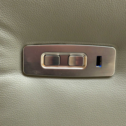 Close-up of the integrated brushed metal power controls and USB charging port on the side of the sofa.