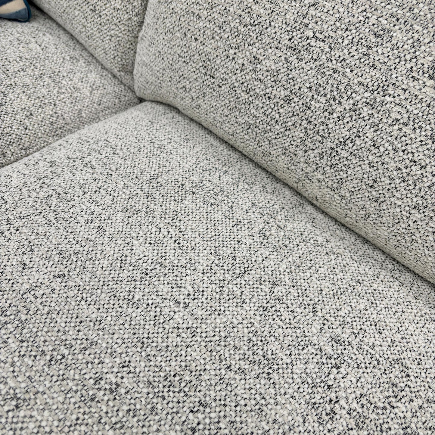 Close-up of the Oyster fabric, highlighting the neutral multi-tonal weave, soft-touch finish, and high-quality upholstery stitching.