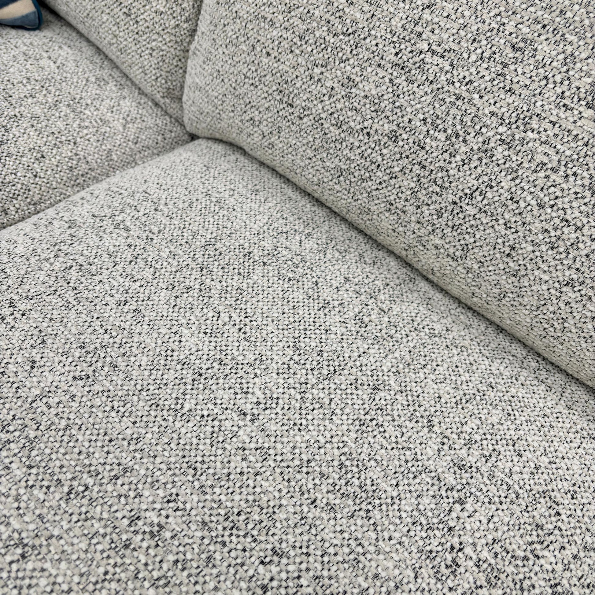 Close-up of the Oyster fabric, highlighting the neutral multi-tonal weave, soft-touch finish, and high-quality upholstery stitching.
