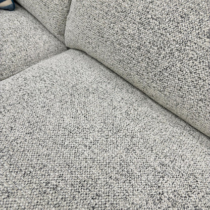 Close-up of the Oyster fabric, highlighting the neutral multi-tonal weave, soft-touch finish, and high-quality upholstery stitching.