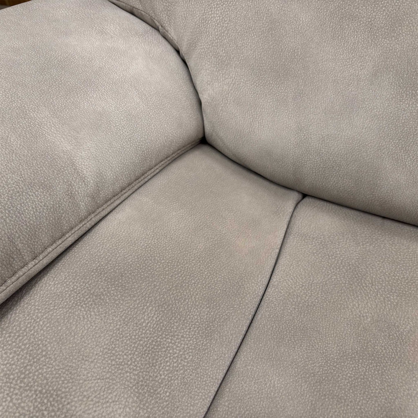 Close-up of the Silver fabric upholstery, highlighting the durable woven texture, subtle sheen, and high-quality contrast stitching.