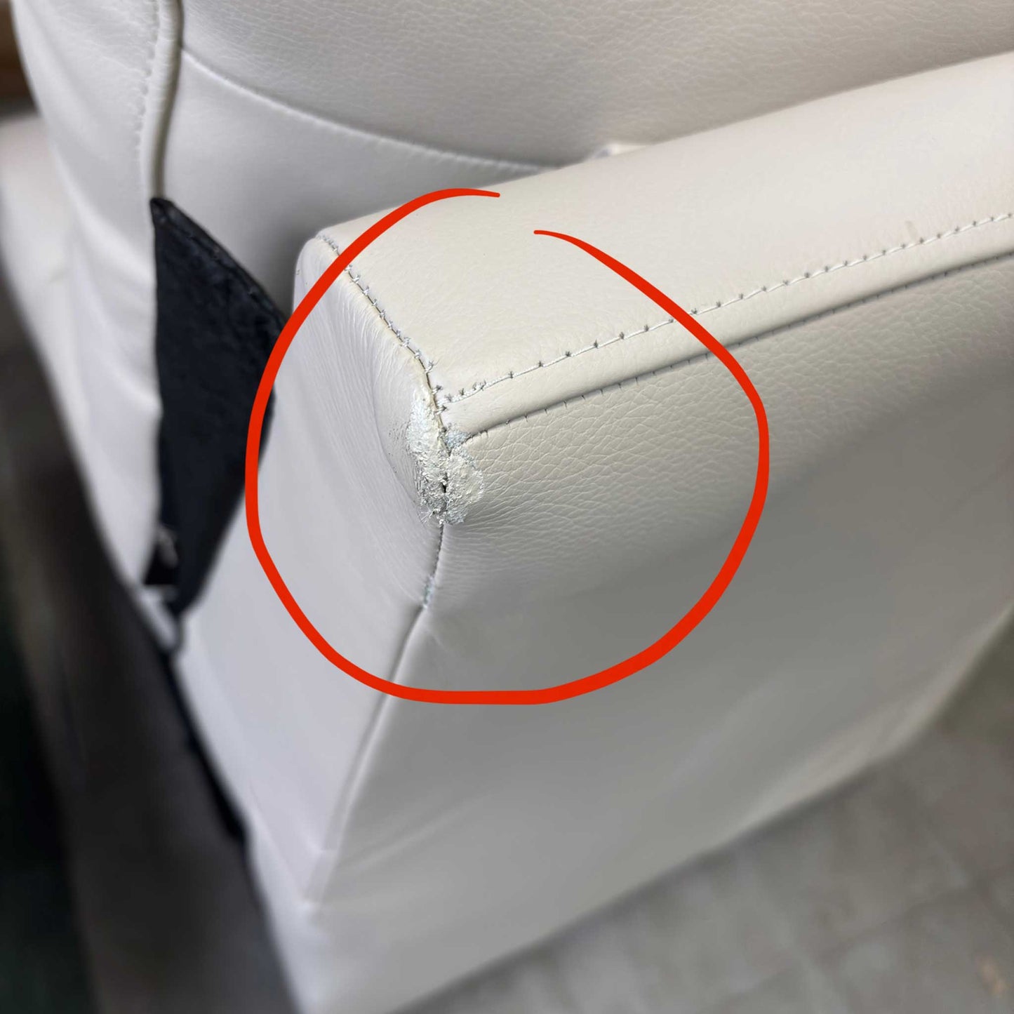 Detail shot of the armrest, showing the damage upholstery area in close up.