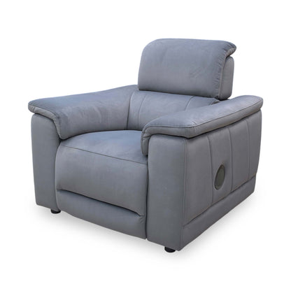 The ‘Genius’ power recliner chair in Bella Iron Grey 43460 velvet, featuring a modern high-back design, padded armrests, and integrated tech features.
