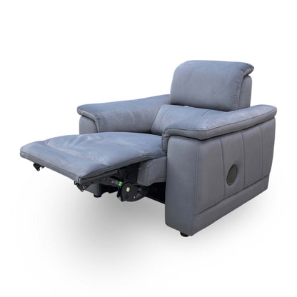 Side profile of the Genius chair in a fully reclined position, emphasizing the ergonomic support and the streamlined integration of the power mechanisms.