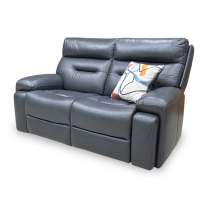 Side profile of the Cinemax sofa, emphasizing the clean contemporary lines and the ergonomic tilt of the high-back headrest design.