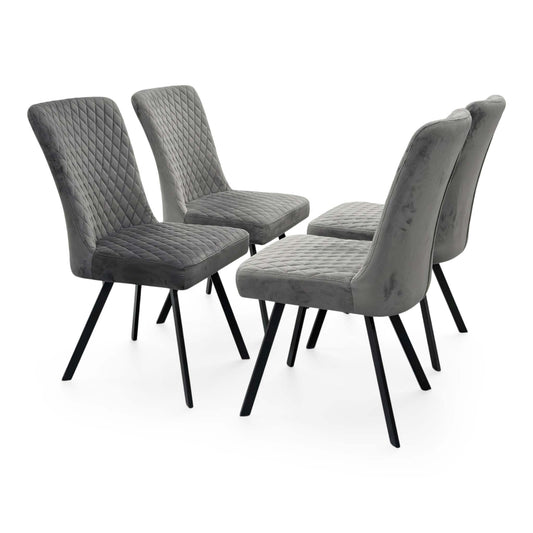 Full view of the set of four Mars Fixed Dining Chairs in Grey Velvet, featuring a contemporary diamond-stitched pattern on the backrest and sleek black metal legs.