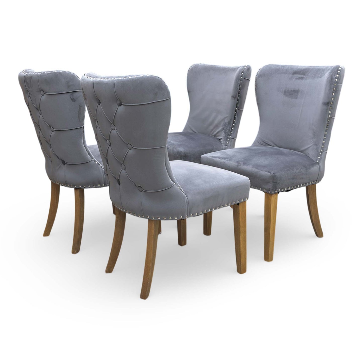 Back view of the Chennai chair, emphasizing the decorative silver ring knocker and the seamless tailored finish of the grey velvet across the backrest.