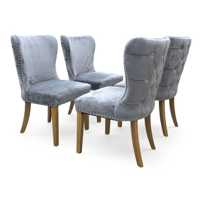 Side view of the Chennai chair, emphasizing the elegant roll-top design and the clean, seamless upholstery finish suitable for formal dining rooms.