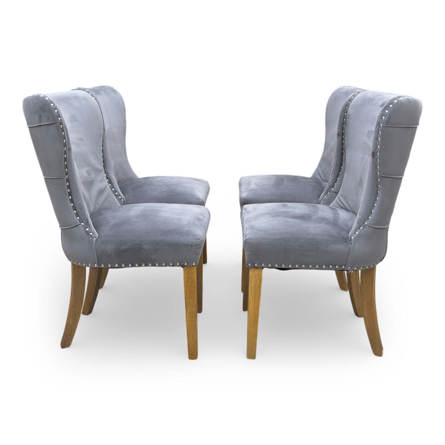 Side shot of the tapered black wooden legs, showing the stable foundation and the floor-protective glides on the base of the chair.