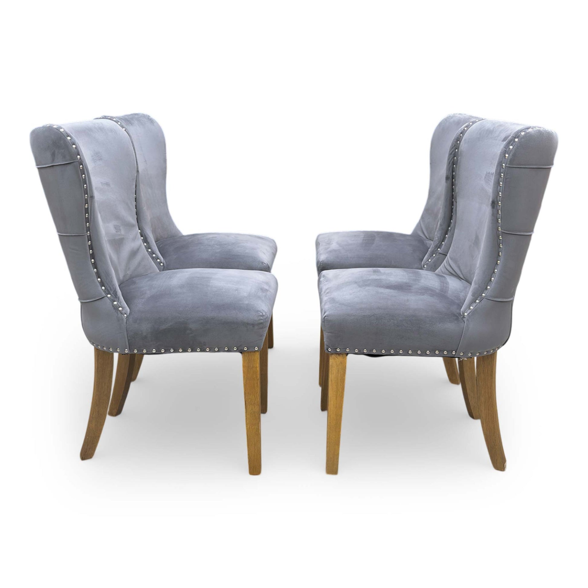 Side shot of the tapered black wooden legs, showing the stable foundation and the floor-protective glides on the base of the chair.