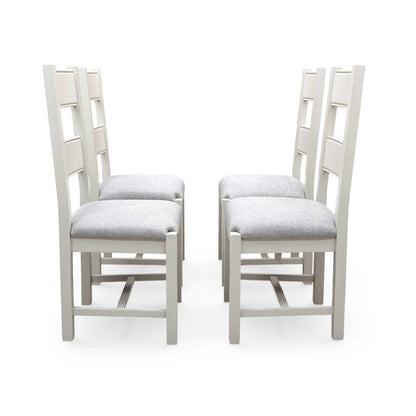 Front view of the Doune chairs, highlighting the firmness of the grey seat cushion and the smooth finish of the wooden slats.