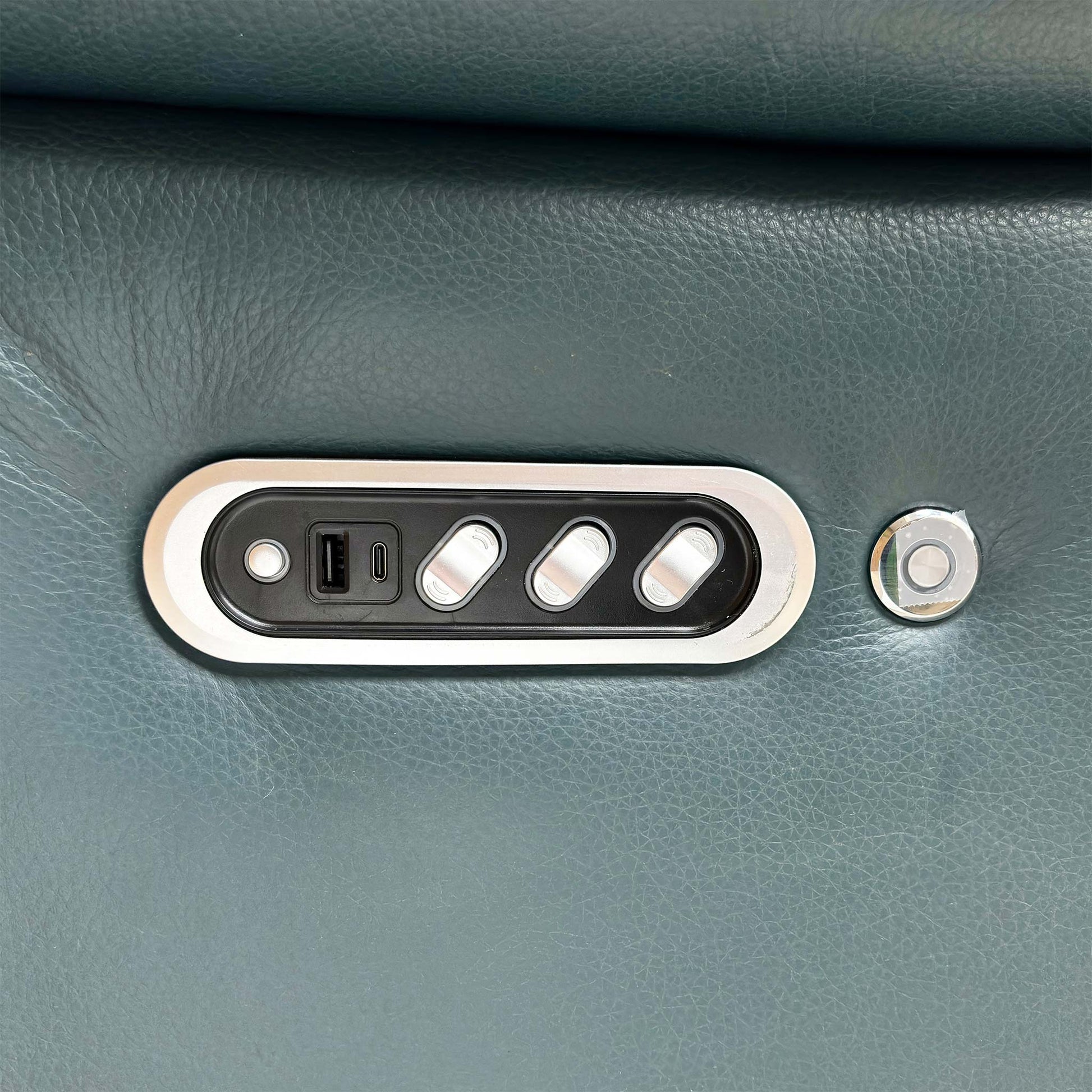 Close-up of the Midnight Jade matte leather upholstery, highlighting the high-quality grain, soft-touch texture, and premium tonal stitching.
