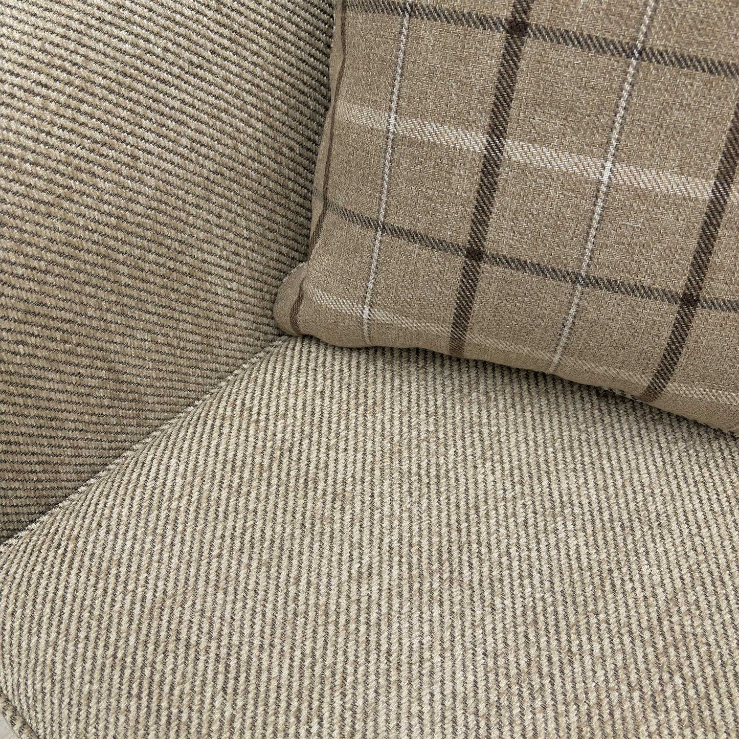 Macro detail shot of the Sophie Sultan sofa bed's stitching and finished edges in oatmeal woven material.