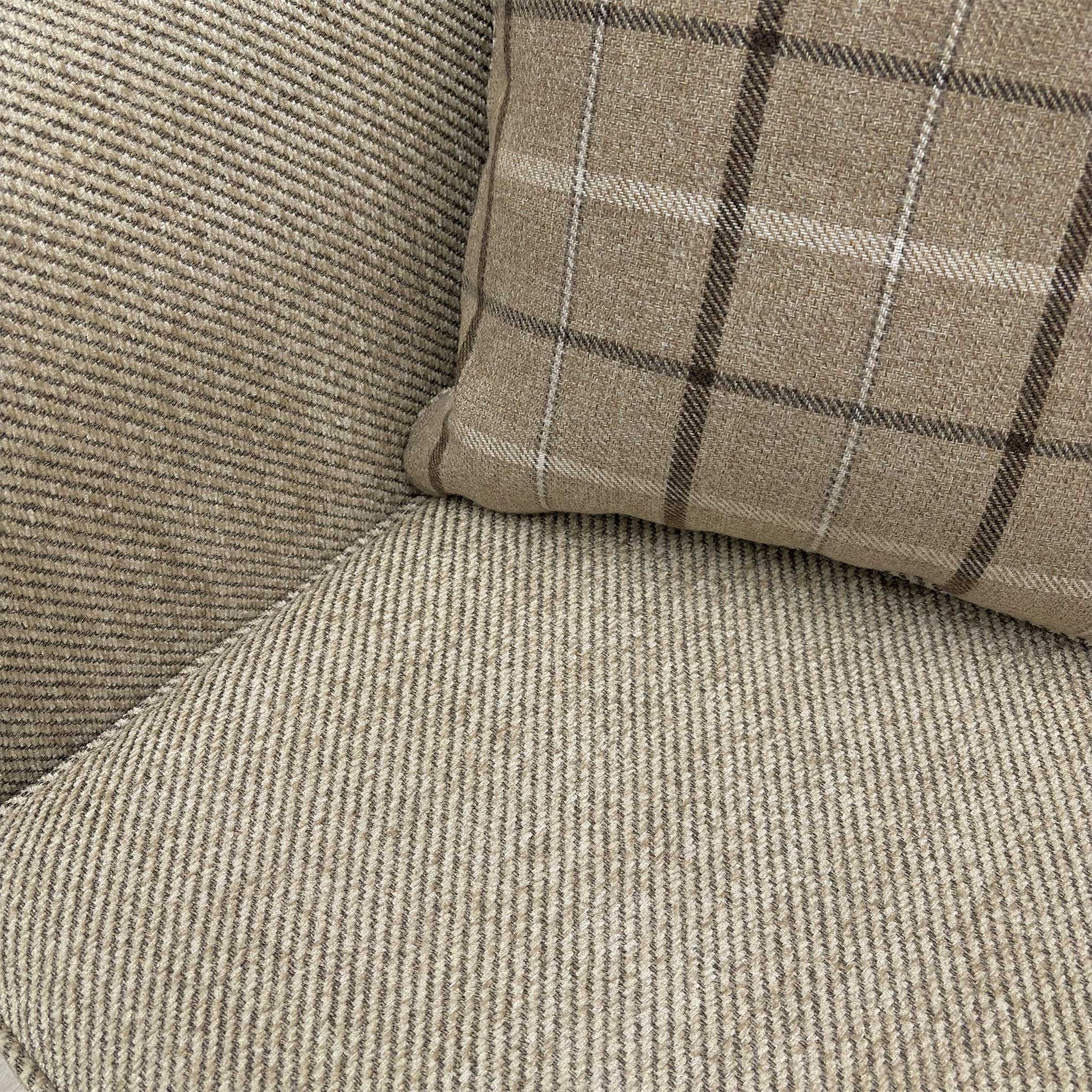 Macro detail shot of the Sophie Sultan sofa bed's stitching and finished edges in oatmeal woven material.
