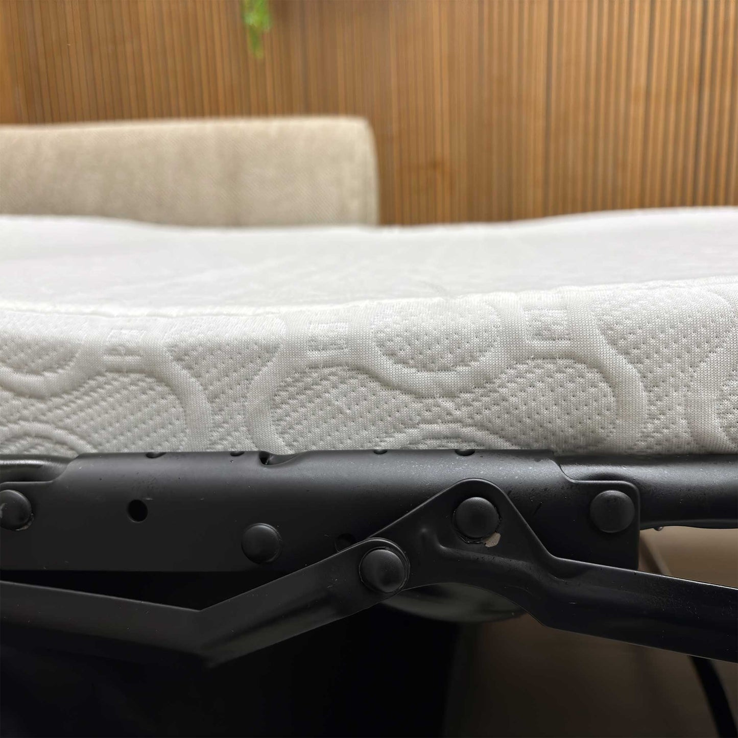 Detailed view of the Sophie Sultan sofa bed's tapered armrest, showing the consistency of the oatmeal woven fabric.