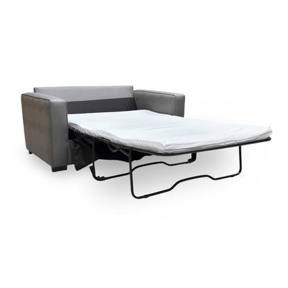 Extended shot of Newton sofa bed converted into its bed configuration, illustrating the flat sleeping surface for guests.