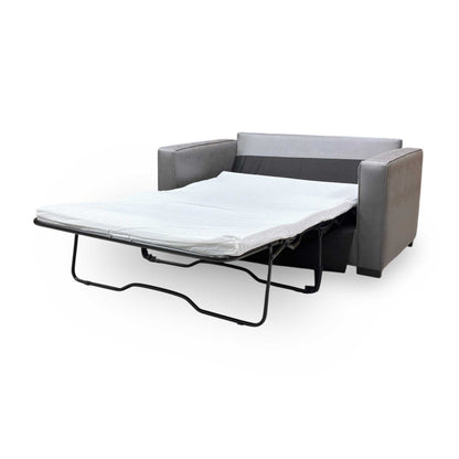 Extended shot of Newton sofa bed converted into its bed configuration, illustrating the flat sleeping surface for guests.