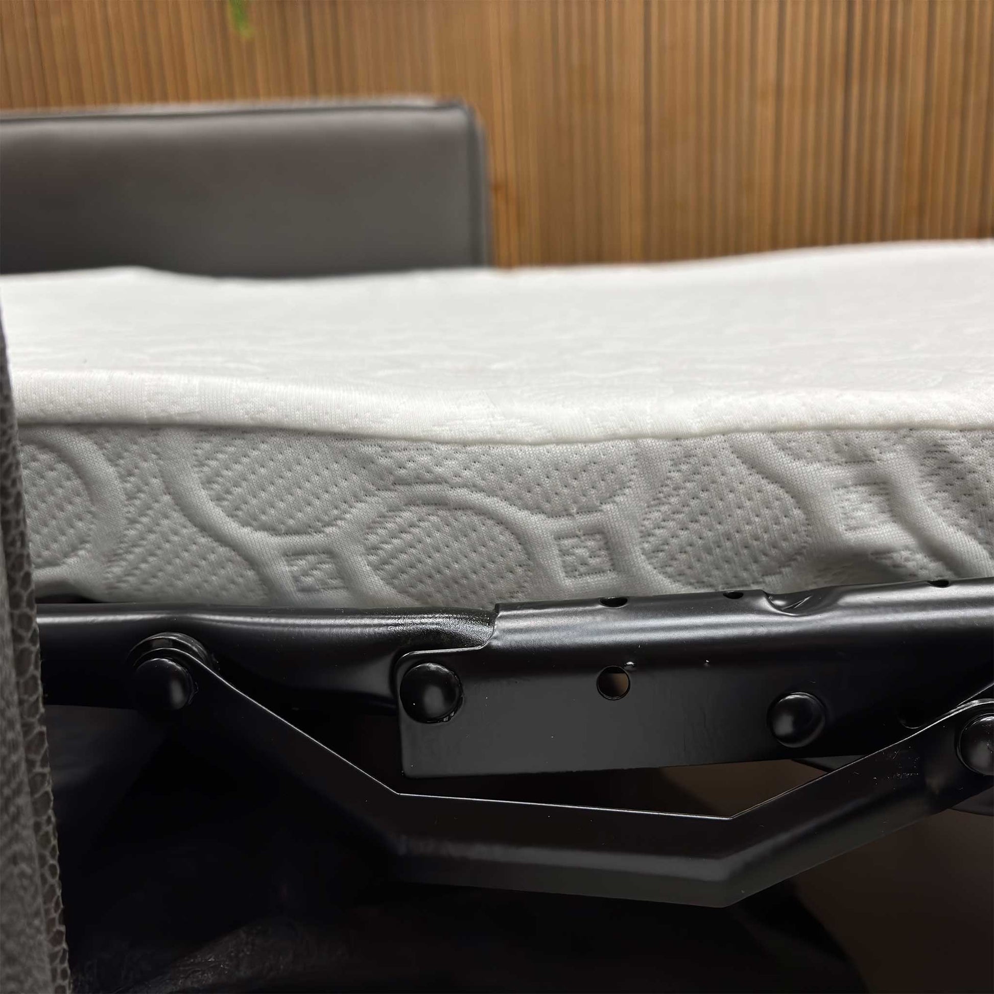 Close up view of the sturdy frame of the Newton Grey Snake faux leather sofa bed.