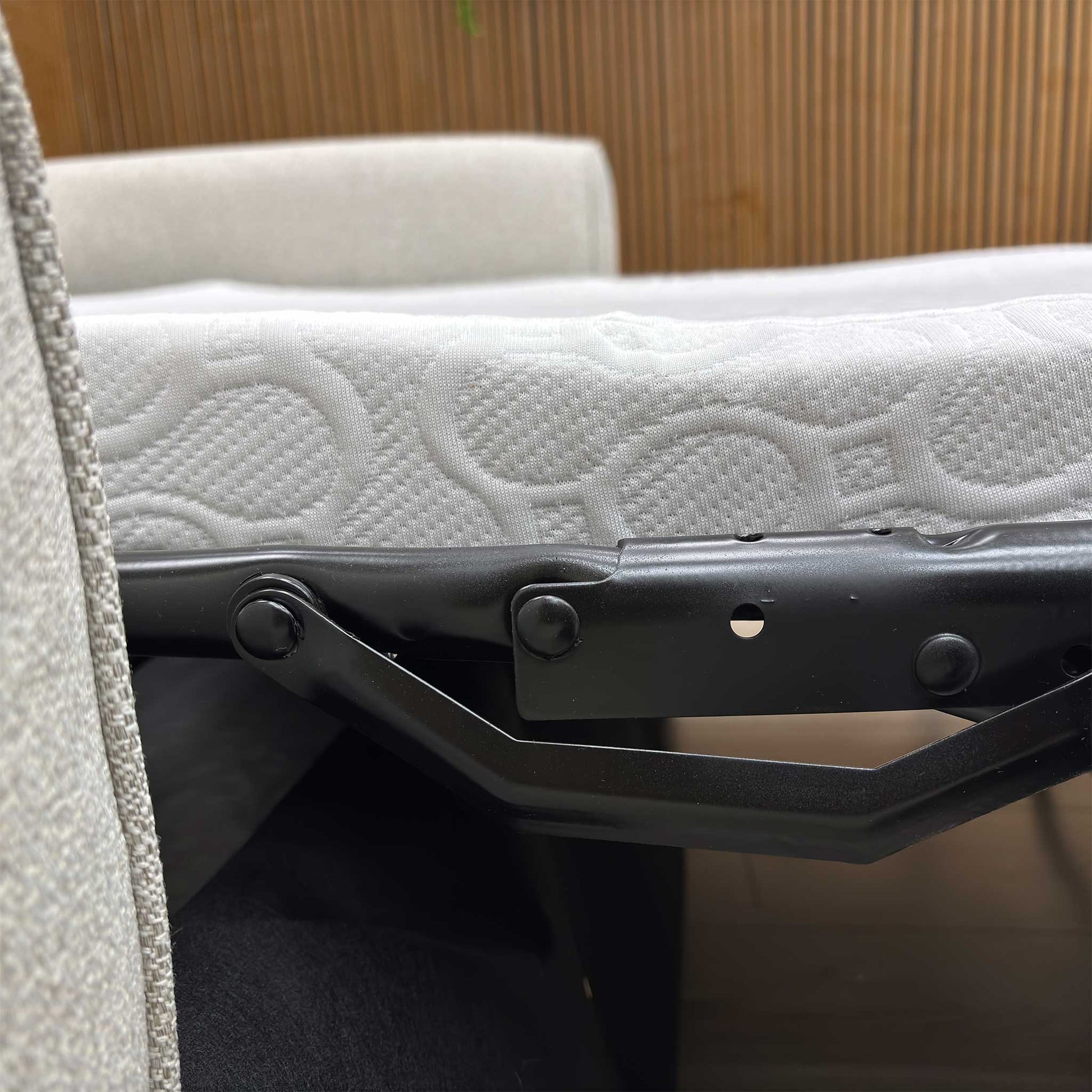 Close up shot of the Albany sofa converted into a bed, revealing the quilted foam mattress and woven support base for a comfortable night's sleep.