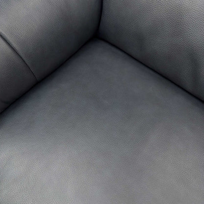 Close-up of the soft 100% Jet Black leather upholstery, highlighting the piped edges, understated buttoning, and high-quality grain.