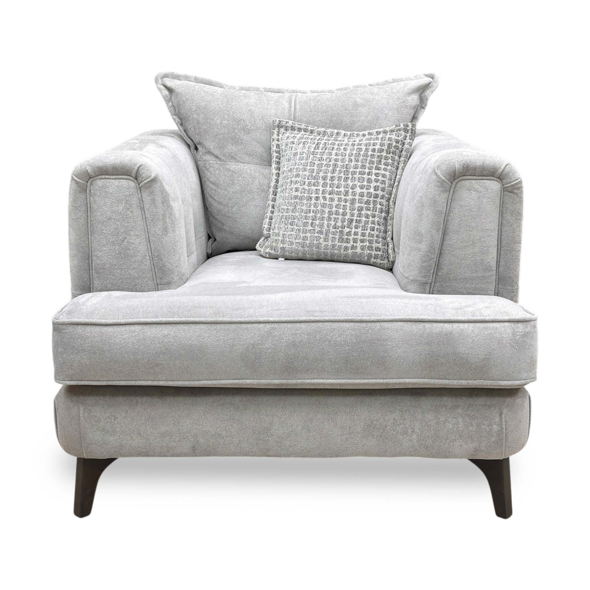 Front profile of the Farrah armchair, emphasizing the graceful angle of the backrest and the tailored finish of the silver fabric upholstery.
