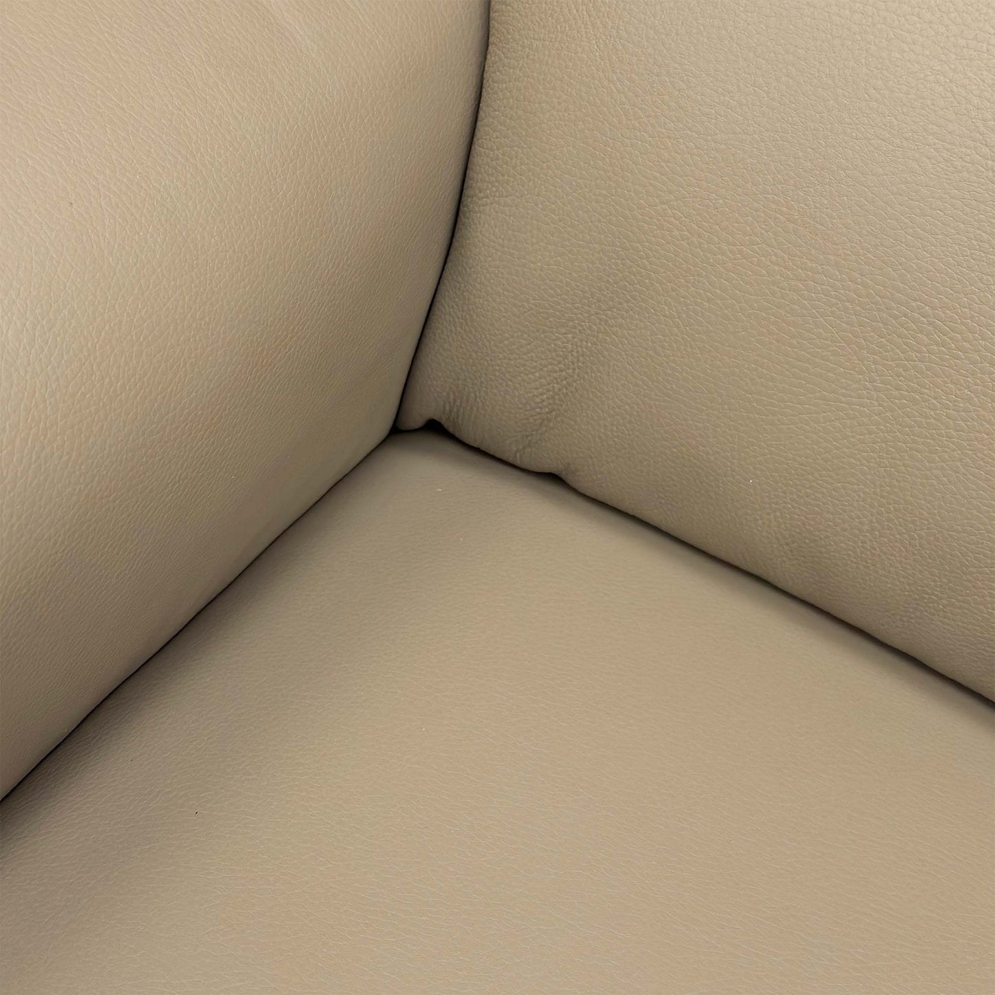 Extreme close-up of the Torello Taupe leather, illustrating the fine grain, rich color, and premium quality of the Nicoletti upholstery.