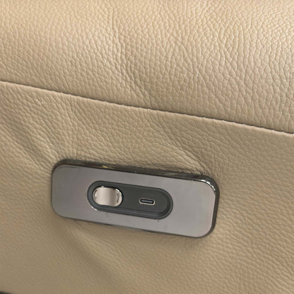 Close-up of the discrete power recliner buttons on the side of the sofa seat for effortless control of the motorized sections.