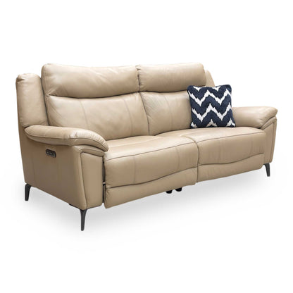 Side profile of the cream leather sofa, showing the modern open-base look and slender metal leg detail.